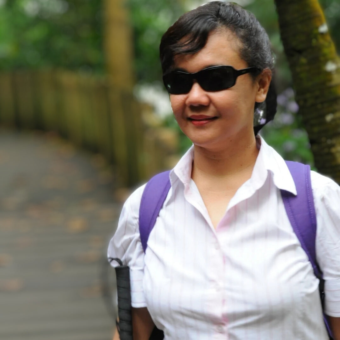 Author Sherri Eri smiling in her signature sunglasses at a 'Picture the Book' event in Singapore. A portrait of the inclusive storyteller and founder of the 'Story-Oke' series.
